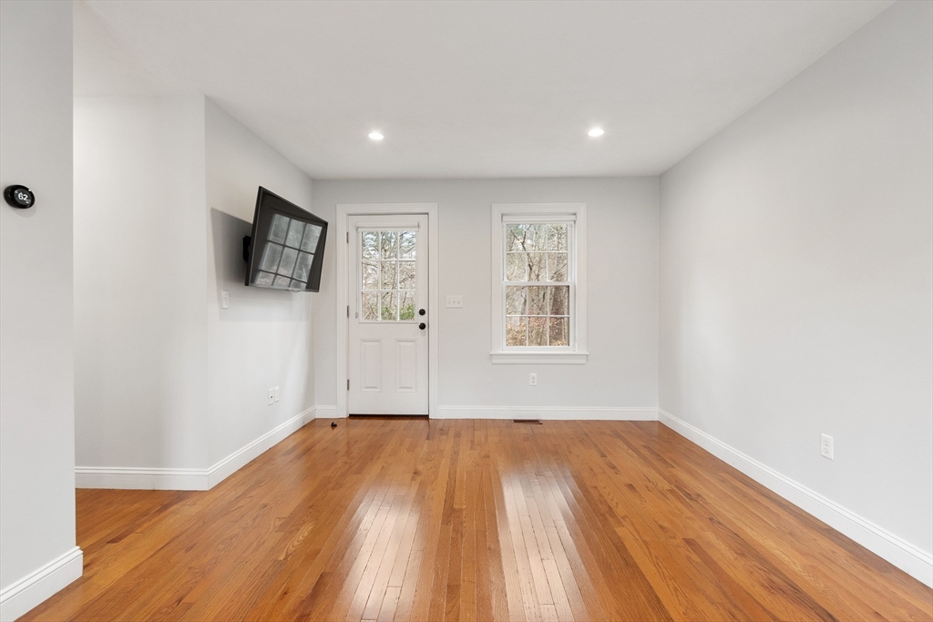 166 Parker Street, Unit 4 Maynard, MA 01754 - Photo 17 of 37 a view of empty room with wooden floor and fan