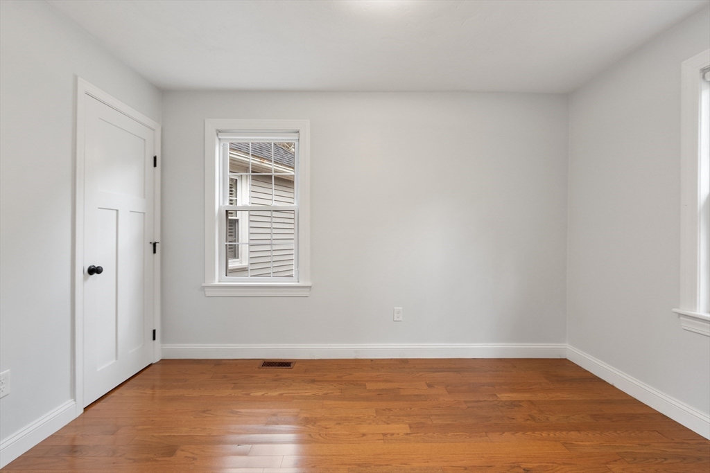 166 Parker Street, Unit 4 Maynard, MA 01754 - Photo 21 of 37 a view of an empty room with wooden floor and a window