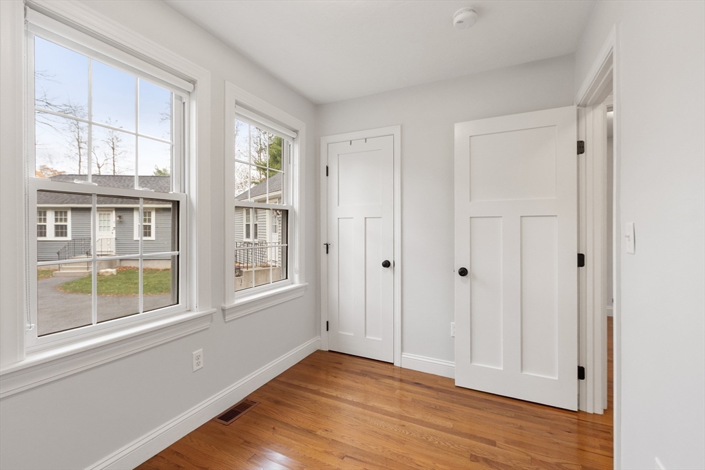 166 Parker Street, Unit 4 Maynard, MA 01754 - Photo 24 of 37 a view of an empty room with wooden floor and a window