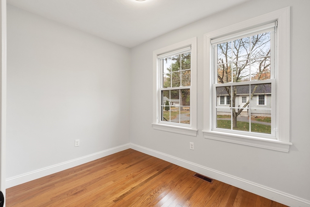 166 Parker Street, Unit 4 Maynard, MA 01754 - Photo 25 of 37 an empty room with wooden floor and windows