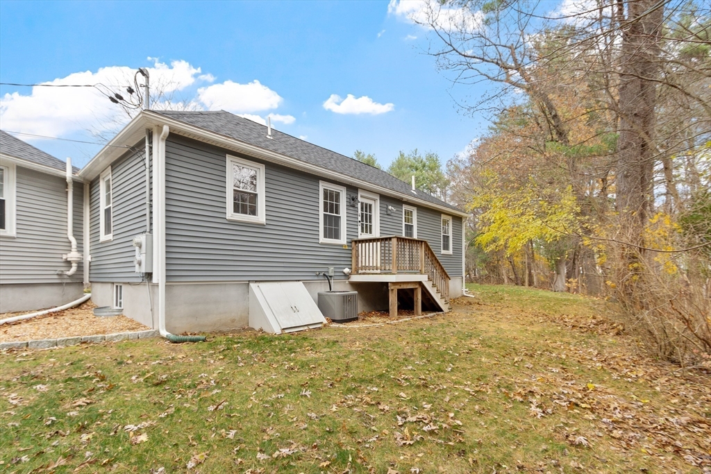 166 Parker Street, Unit 4 Maynard, MA 01754 - Photo 29 of 37 a view of a house with a yard and garage