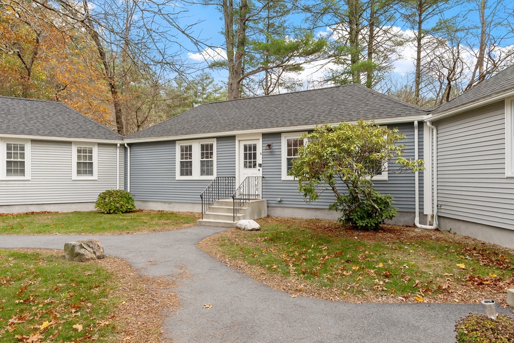 166 Parker Street, Unit 4 Maynard, MA 01754 - Photo 4 of 37 a front view of house with yard and green space
