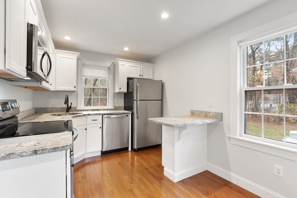 166 Parker Street, Unit 4 Maynard, MA 01754 - Photo 10 of 37 a kitchen with a sink a stove a refrigerator and a window