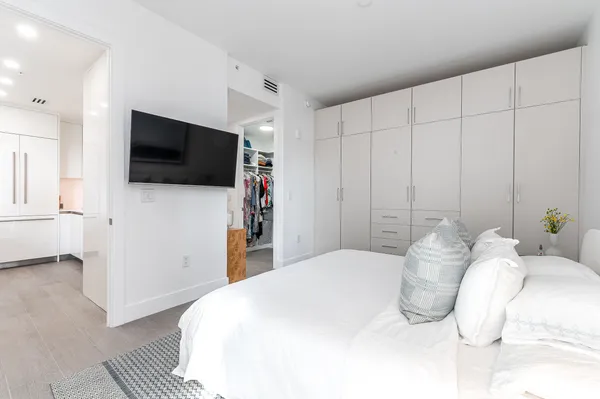 a bedroom with a bed and a flat screen tv