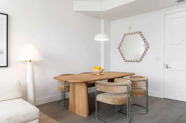 a view of a room that has a table and a chair in it