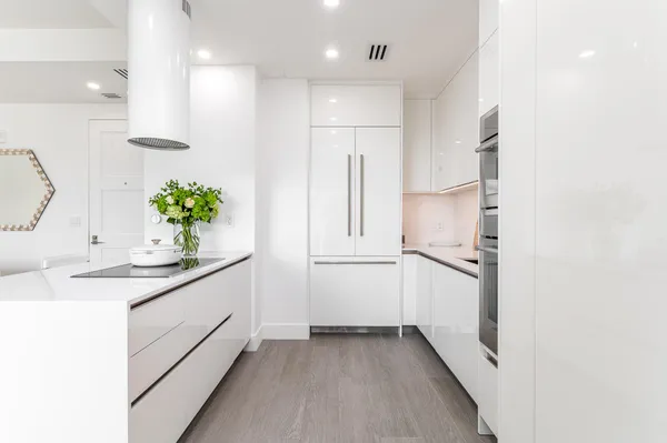 a kitchen with a sink and refrigerator
