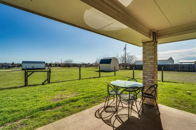 a view of a chairs and table in patio