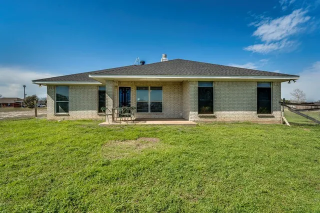 a house view with a sitting space and garden
