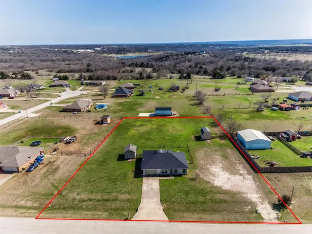 an aerial view of a house with a yard