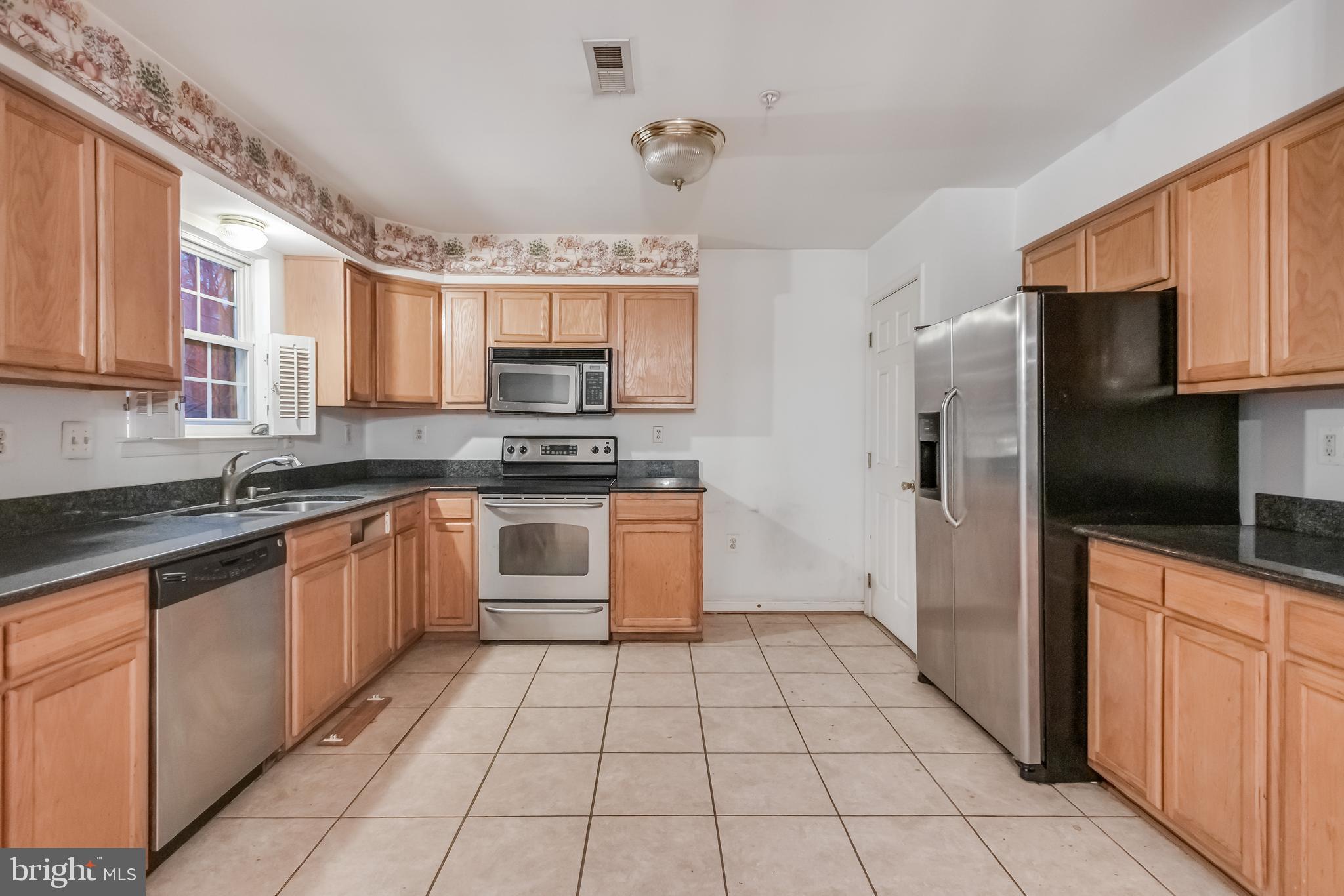 14107 Kydon Court Brandywine, MD 20613 - Photo 2 of 27 a kitchen with stainless steel appliances granite countertop a refrigerator and a stove top oven