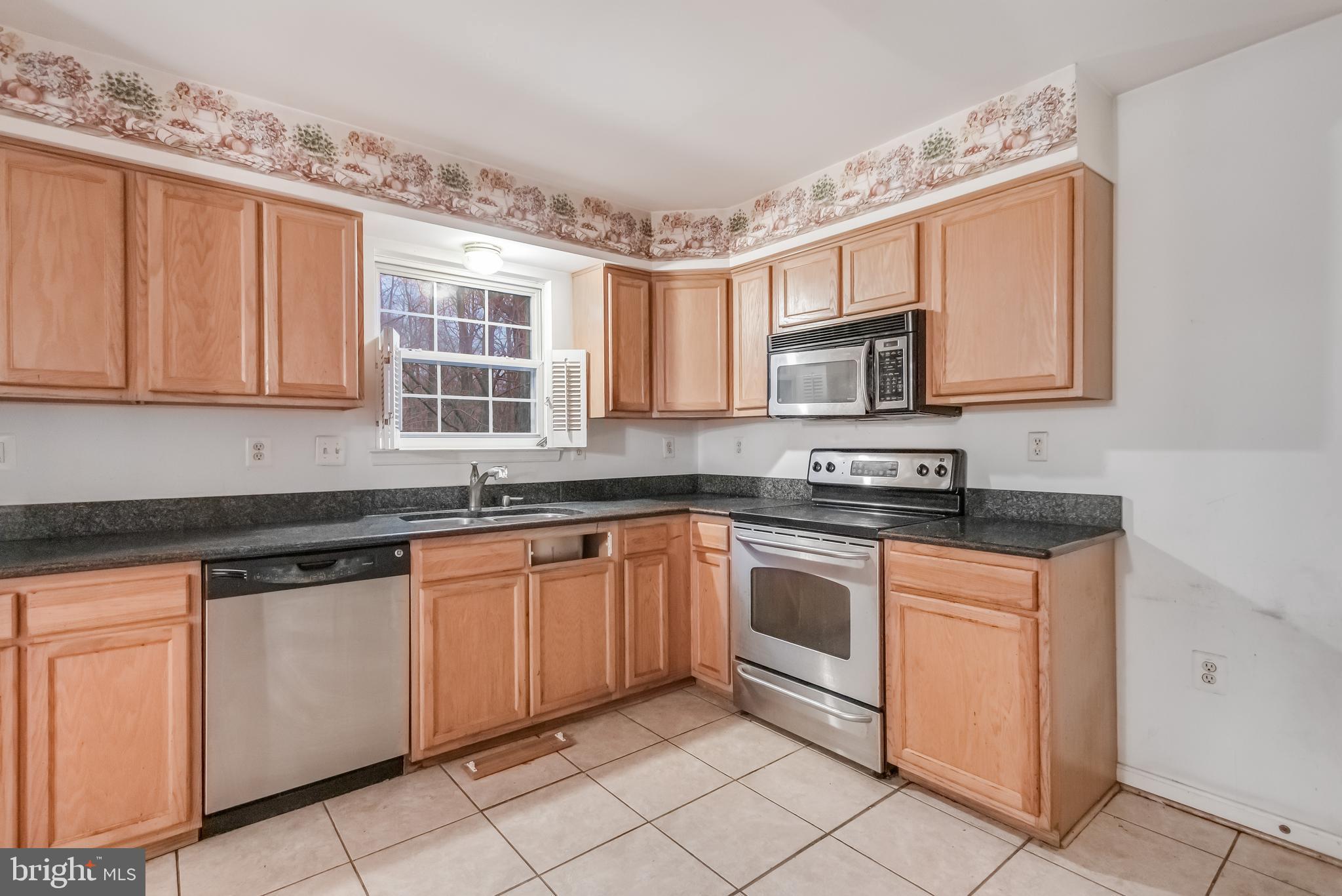14107 Kydon Court Brandywine, MD 20613 - Photo 3 of 27 a kitchen with stainless steel appliances granite countertop a stove sink and cabinets