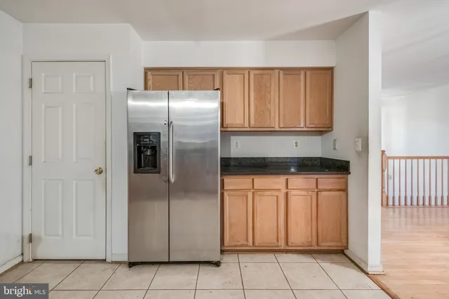 a kitchen with stainless steel appliances granite countertop a refrigerator