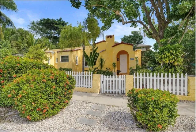 a view of a house with wooden fence