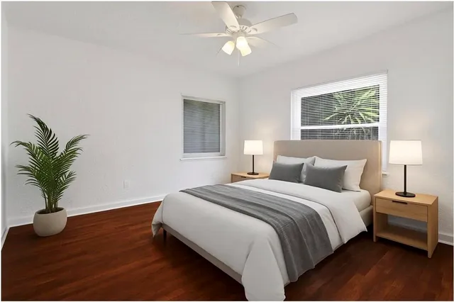 a bedroom with a bed and a window