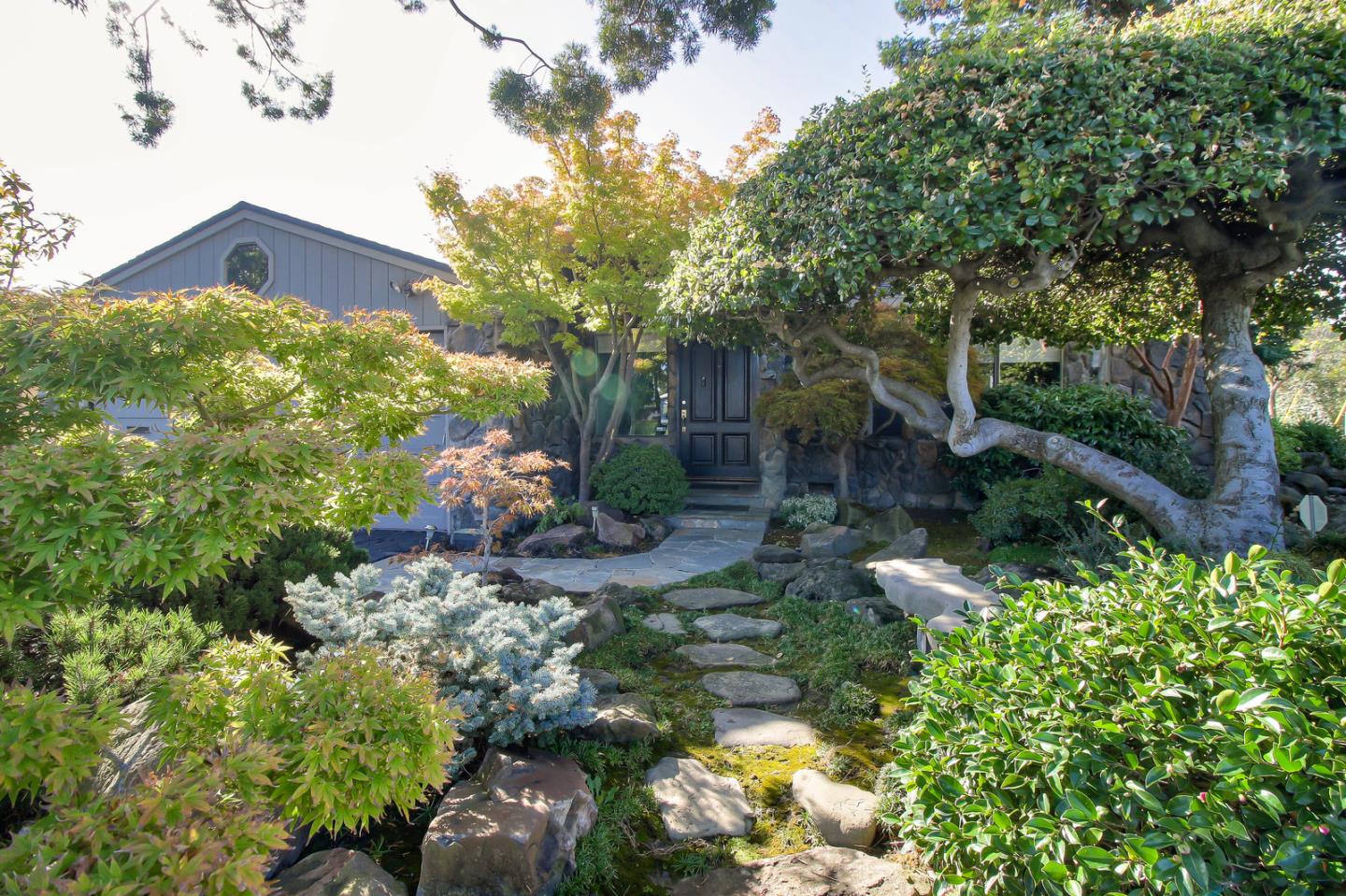5998 Sutton Park Place Cupertino, CA 95014 - Photo 1 of 6 a backyard of a house with lots of green space and garden