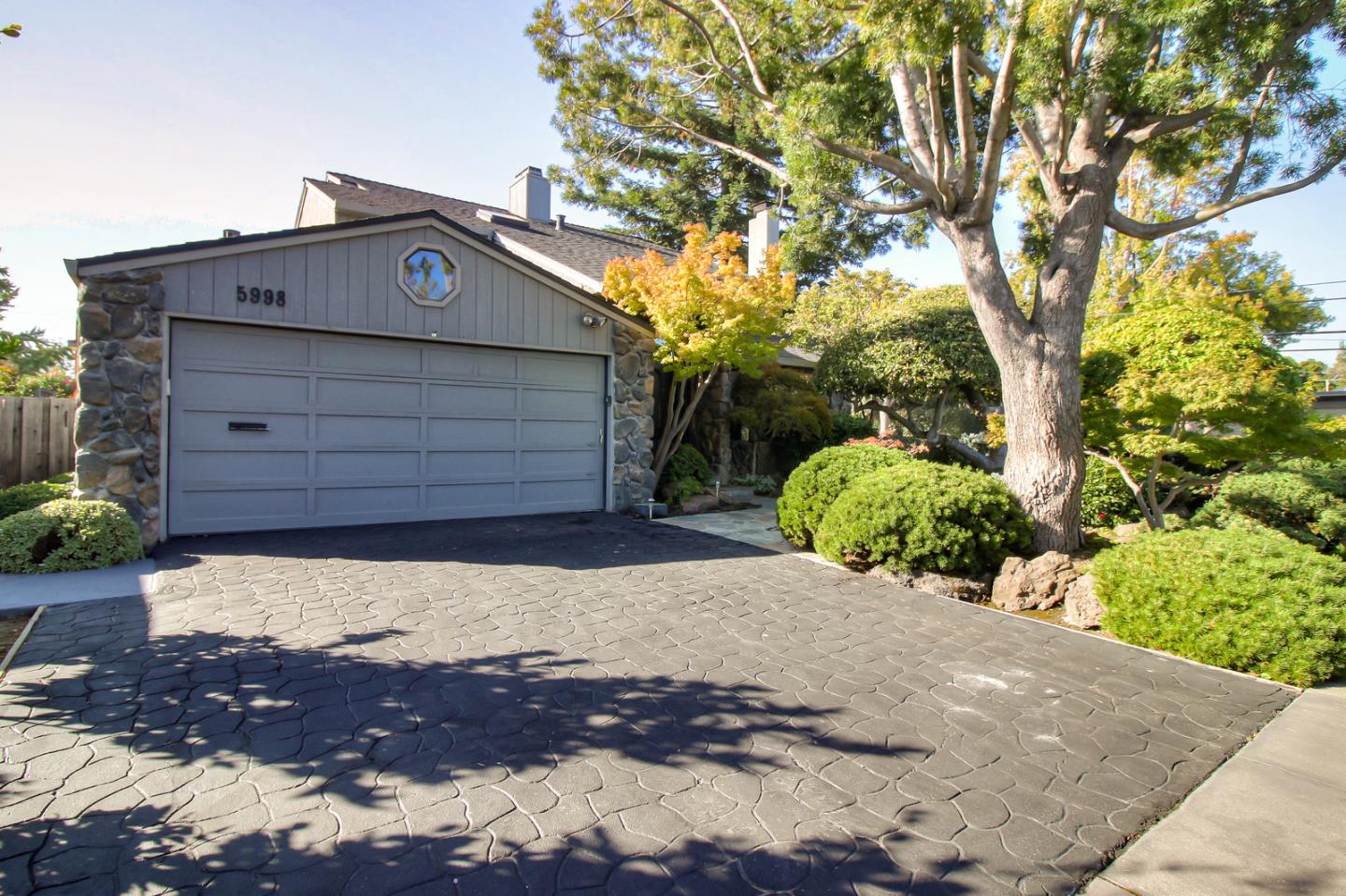 5998 Sutton Park Place Cupertino, CA 95014 - Photo 2 of 6 a view of a house with a large tree
