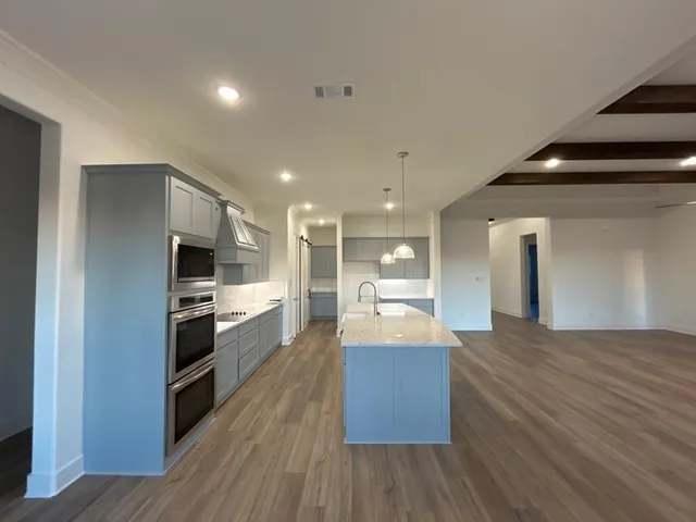 a large kitchen with kitchen island a sink dishwasher stove and refrigerator