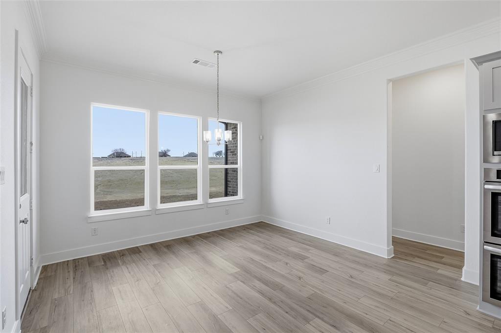 808 Vly Rdg Road Van Alstyne, TX 75495 - Photo 13 of 39 a view of an empty room with wooden floor and a window