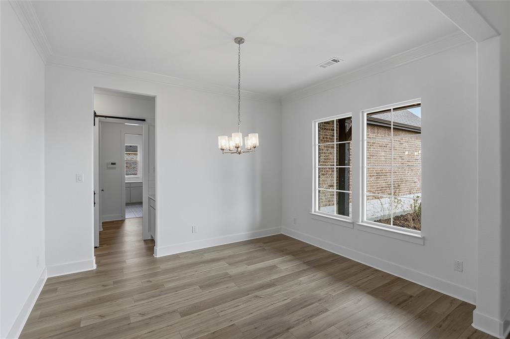 808 Vly Rdg Road Van Alstyne, TX 75495 - Photo 7 of 39 a view of an empty room with wooden floor and a window