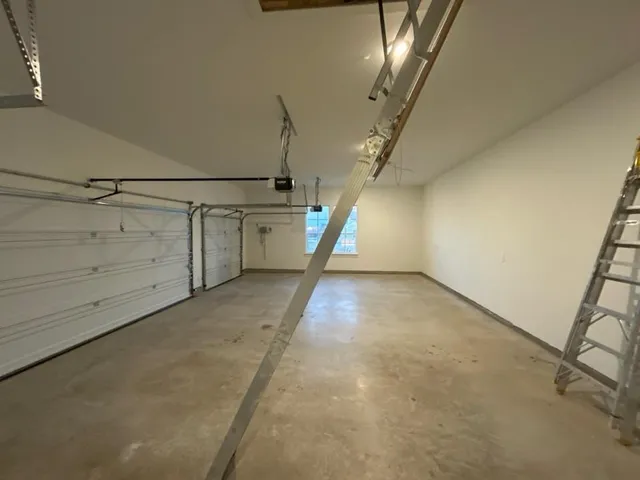 a room with pool table and wooden floor