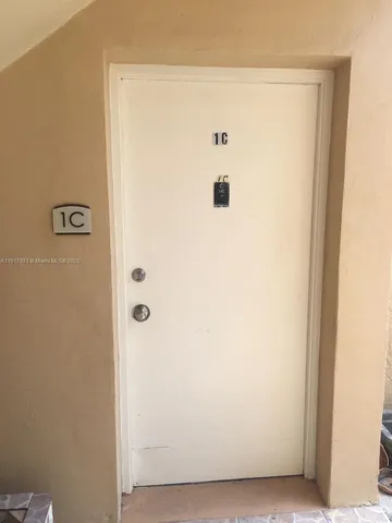 a view of a kitchen with a sink and a refrigerator