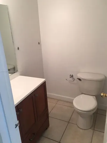 a bathroom with a sink vanity and mirror