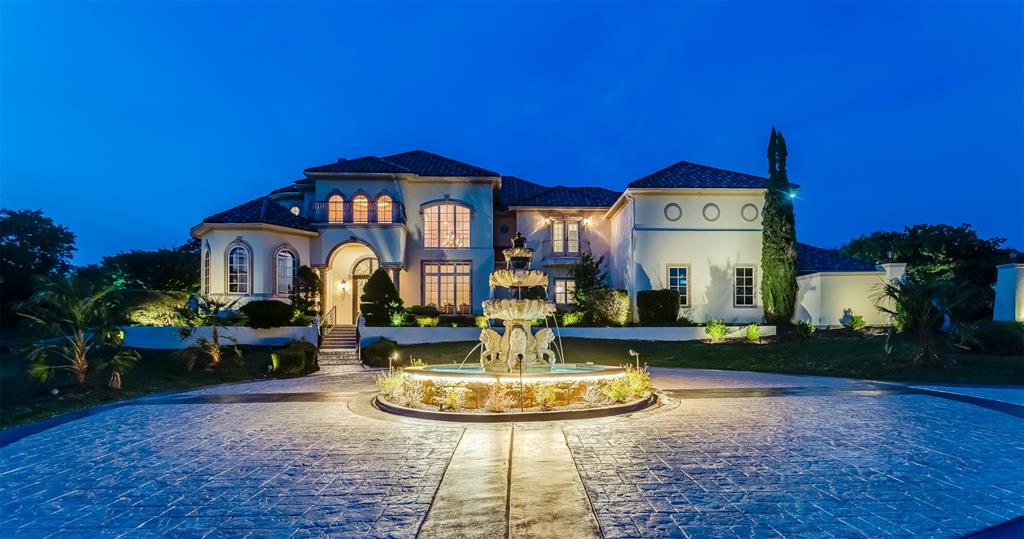 a front view of a house with fountain