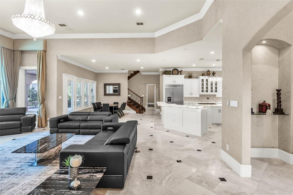 8600 Riviera Court Flower Mound, TX 75022 - Photo 12 of 40 a living room with furniture and a dining table with kitchen view
