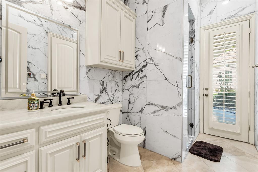 8600 Riviera Court Flower Mound, TX 75022 - Photo 22 of 40 a bathroom with a sink a toilet and a mirror