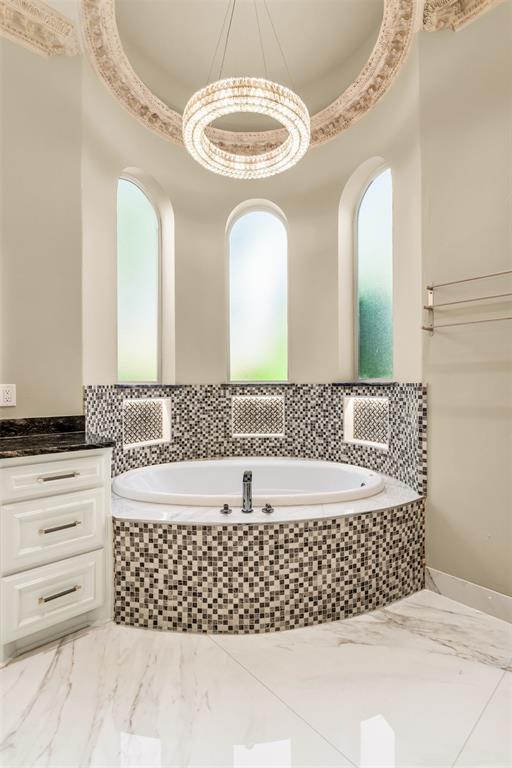 8600 Riviera Court Flower Mound, TX 75022 - Photo 23 of 40 a bathroom with a bathtub and a sink