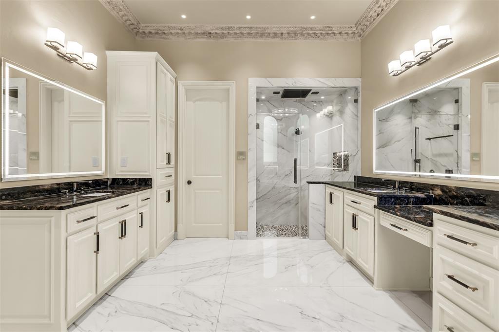 8600 Riviera Court Flower Mound, TX 75022 - Photo 24 of 40 a large white bathroom with a granite countertop double vanity sink a mirror and a shower
