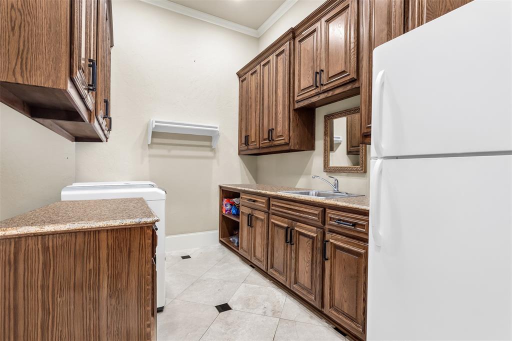 8600 Riviera Court Flower Mound, TX 75022 - Photo 39 of 40 a kitchen with stainless steel appliances granite countertop a stove and a refrigerator