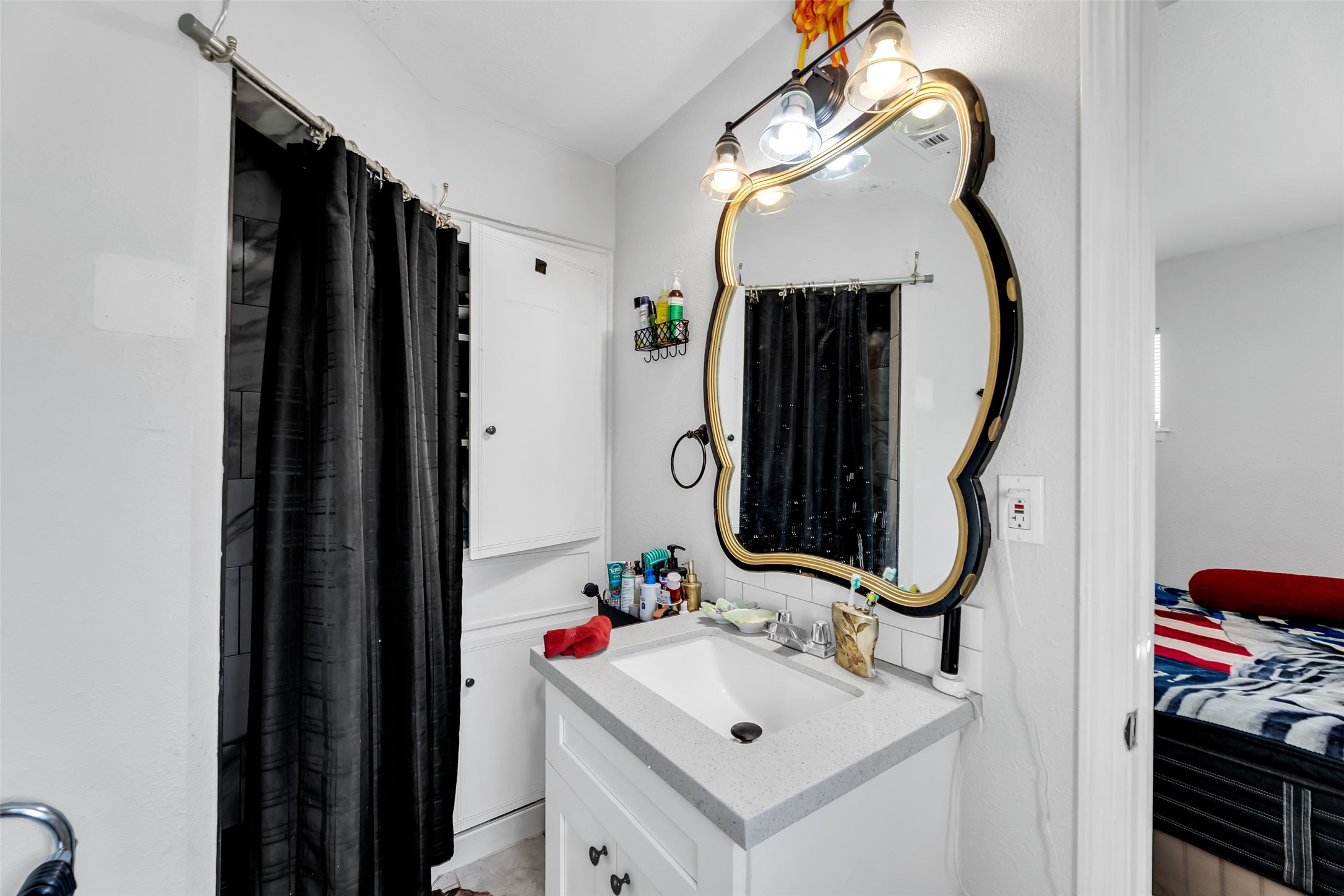 819 Hackberry Street Stafford, TX 77477 - Photo 13 of 23 a bathroom with a sink and a mirror