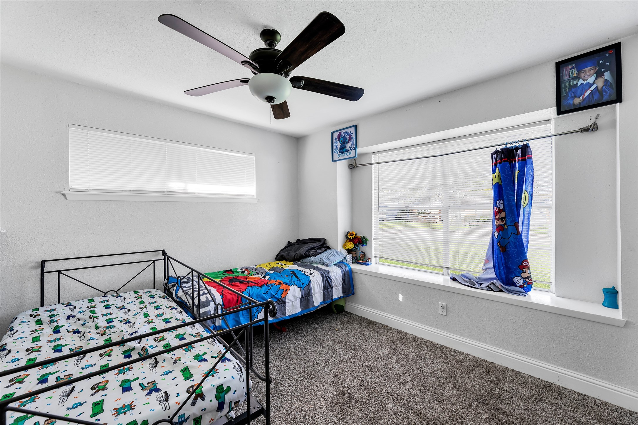 819 Hackberry Street Stafford, TX 77477 - Photo 14 of 23 a bedroom with a bed a window and a chandelier