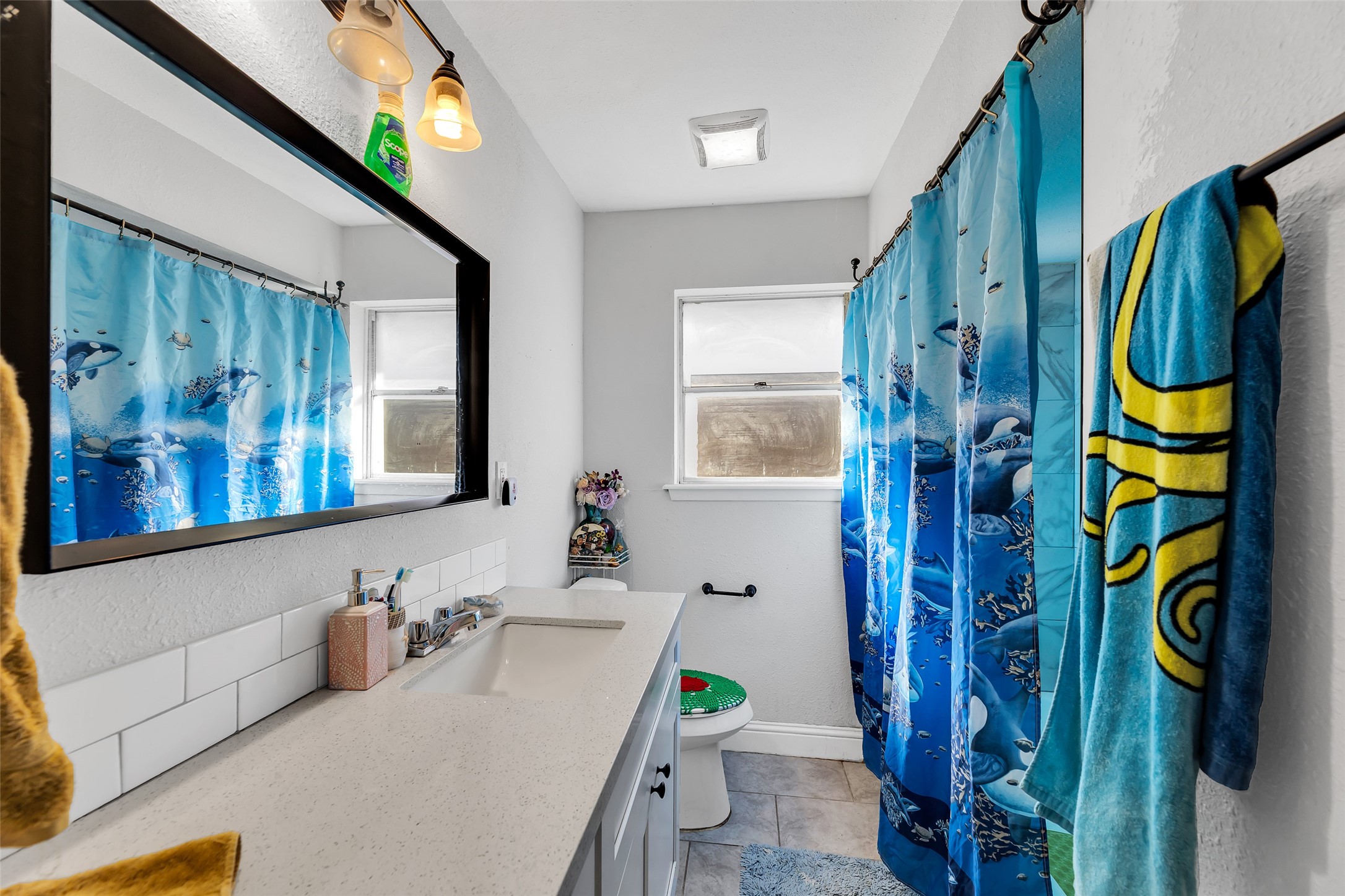 819 Hackberry Street Stafford, TX 77477 - Photo 16 of 23 a bathroom with a sink a toilet and a mirror