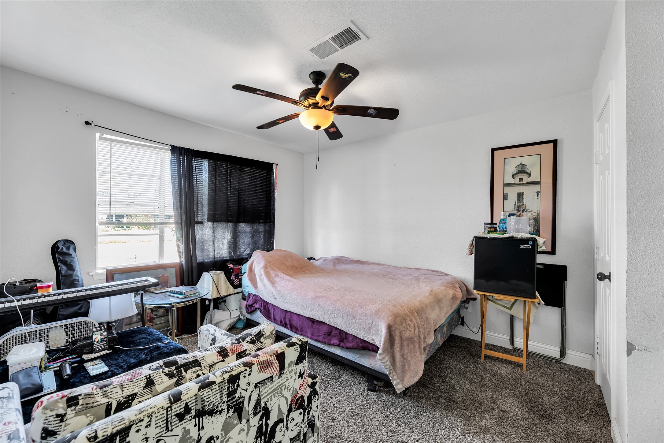 819 Hackberry Street Stafford, TX 77477 - Photo 18 of 23 a bedroom with a bed and a chandelier
