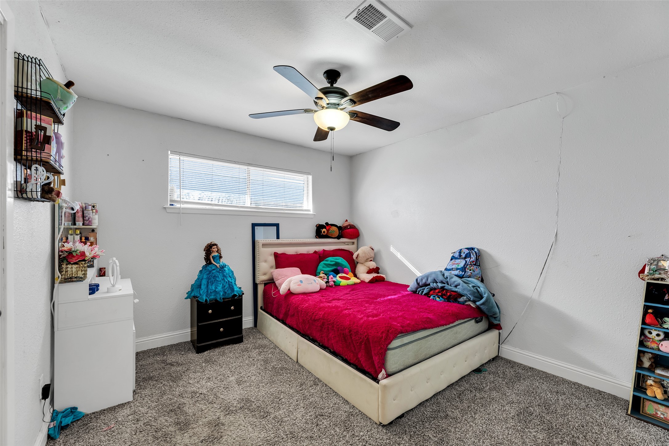 819 Hackberry Street Stafford, TX 77477 - Photo 19 of 23 a bedroom with a bed and a chandelier