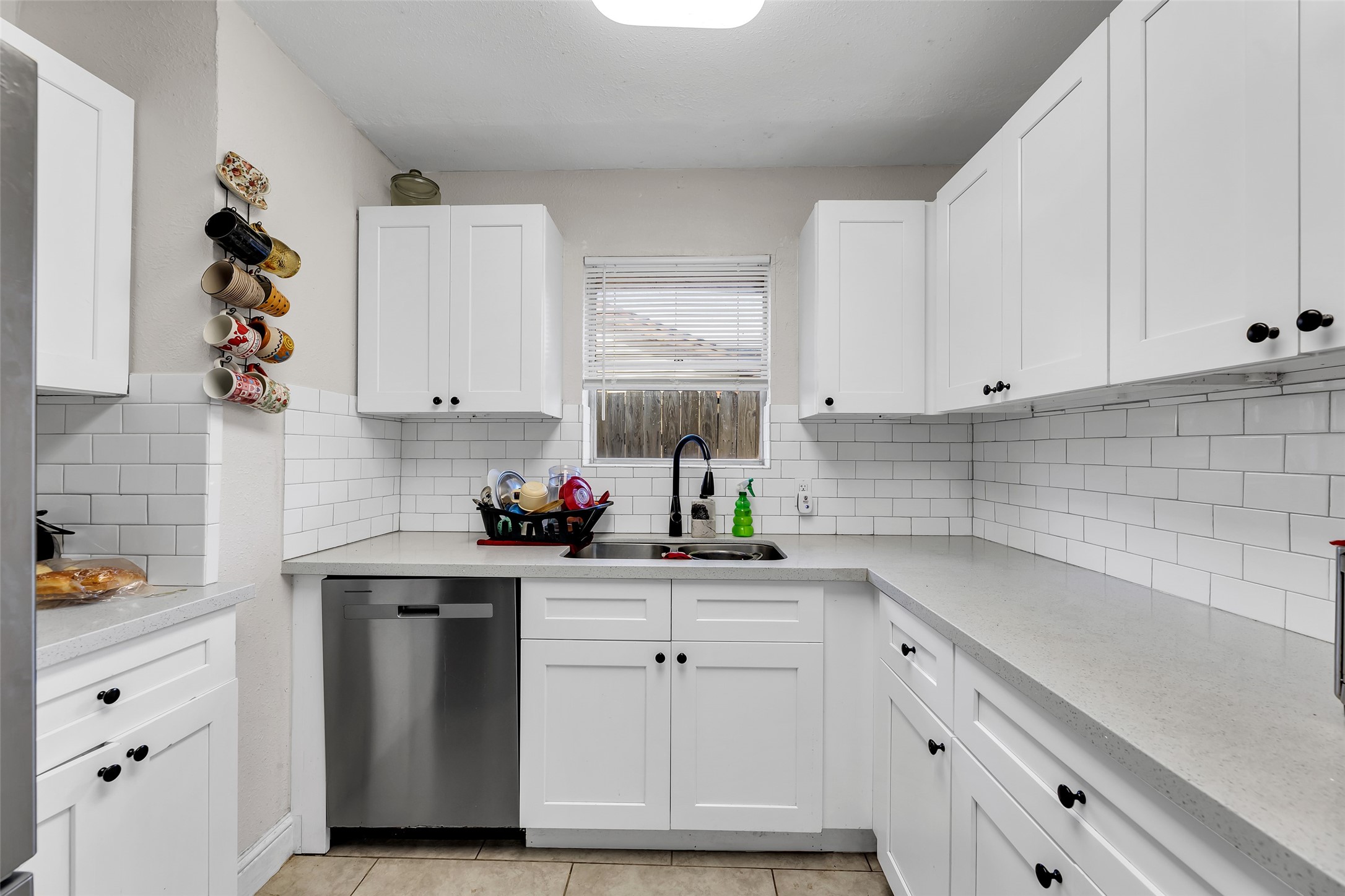 819 Hackberry Street Stafford, TX 77477 - Photo 2 of 23 a kitchen with white cabinets and white appliances