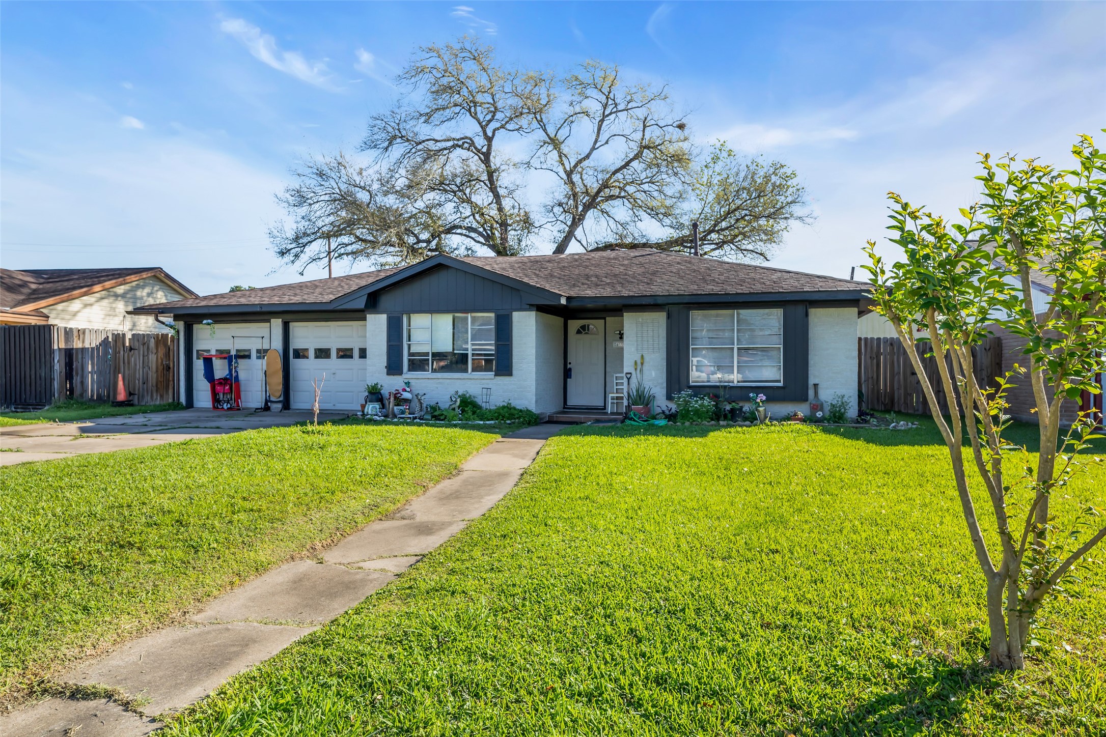 819 Hackberry Street Stafford, TX 77477 - Photo 3 of 23 a front view of a house with a yard table and chairs