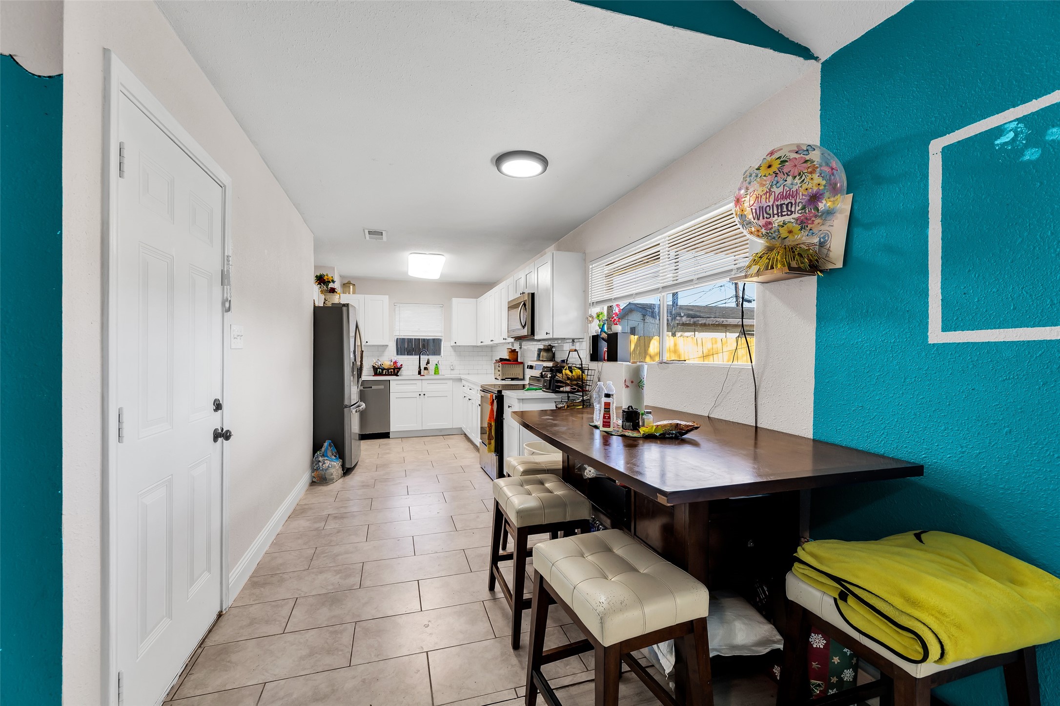 819 Hackberry Street Stafford, TX 77477 - Photo 8 of 23 a dining room with furniture and view kitchen