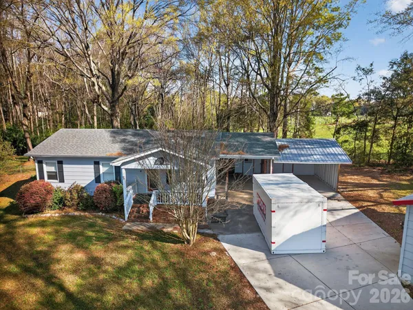 a view of a house with a wooden deck