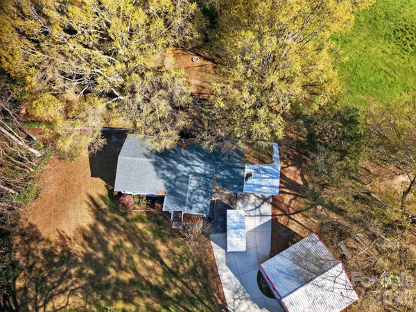 a view of a house with a yard and tree s