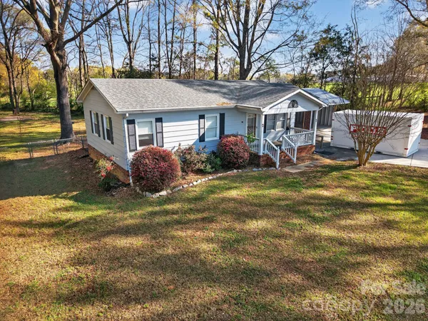 a view of a backyard with wooden fence