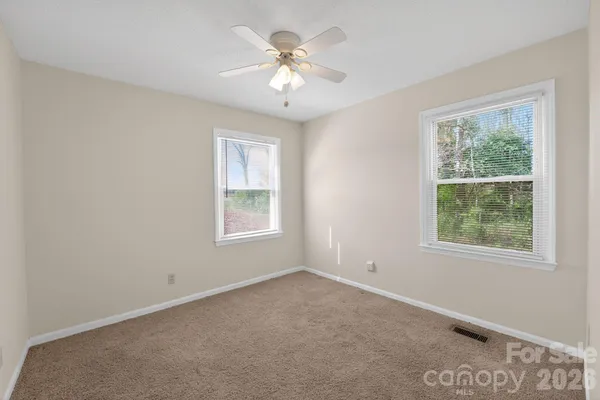 a view of a room with a ceiling fan and a window