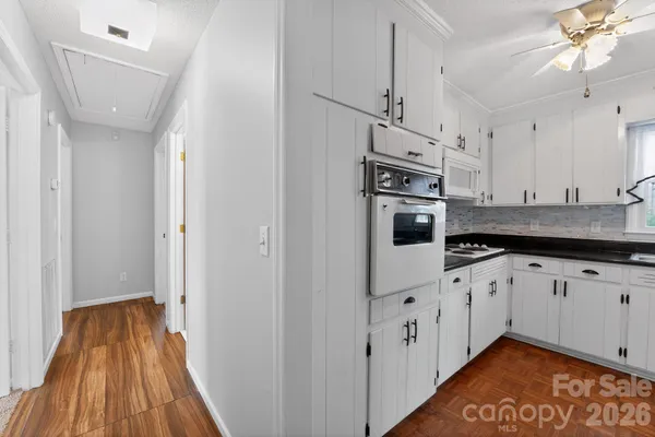 a view of an empty room with window and cabinet
