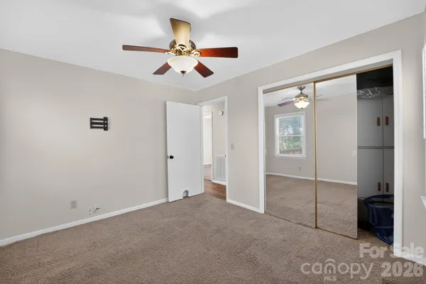 a view of an empty room and a ceiling fan