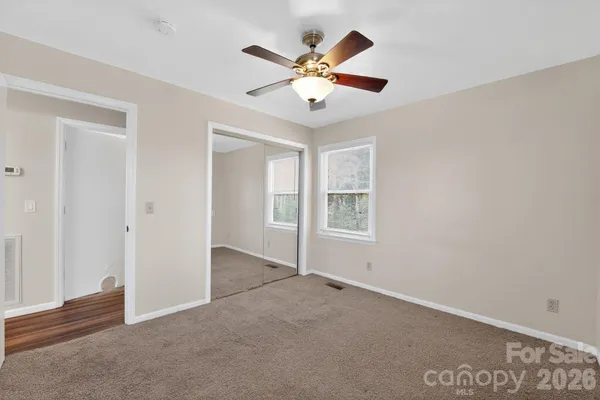a bathroom with a granite countertop sink a toilet and shower