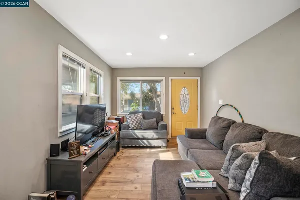a living room with furniture window and a flat screen tv