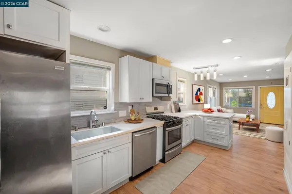 a kitchen with a sink a stove and cabinets