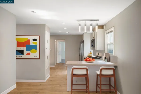 a dining room with furniture and wooden floor